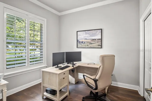 a view of workspace with wooden floor and windows