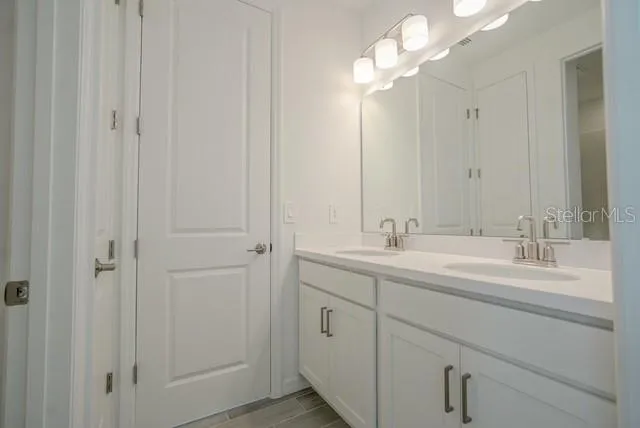 a bathroom with 2 sink and a mirror