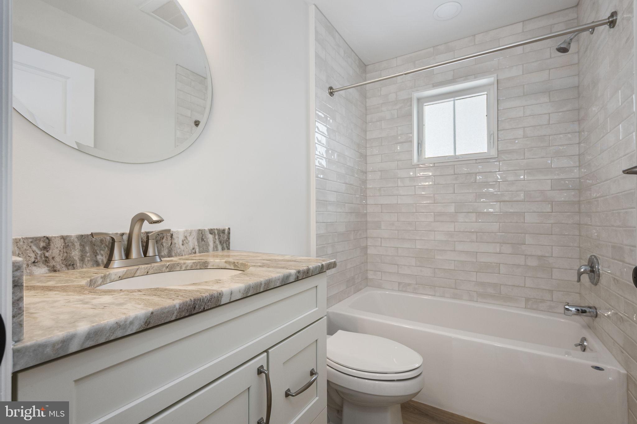 2185 Kimberton Road, Unit 5 Phoenixville, PA 19460 - Photo 31 of 36 a bathroom with a granite countertop sink a toilet and bathtub