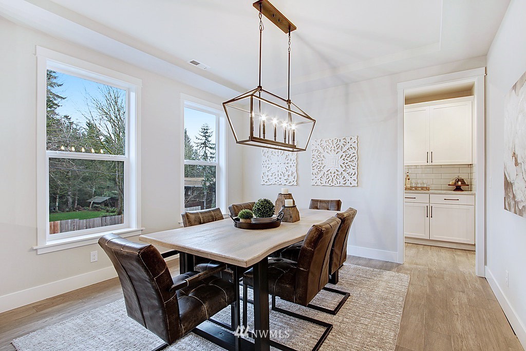 17718 Clover Road Bothell, WA 98012 - Photo 11 of 24 a view of a dining room with furniture window and wooden floor