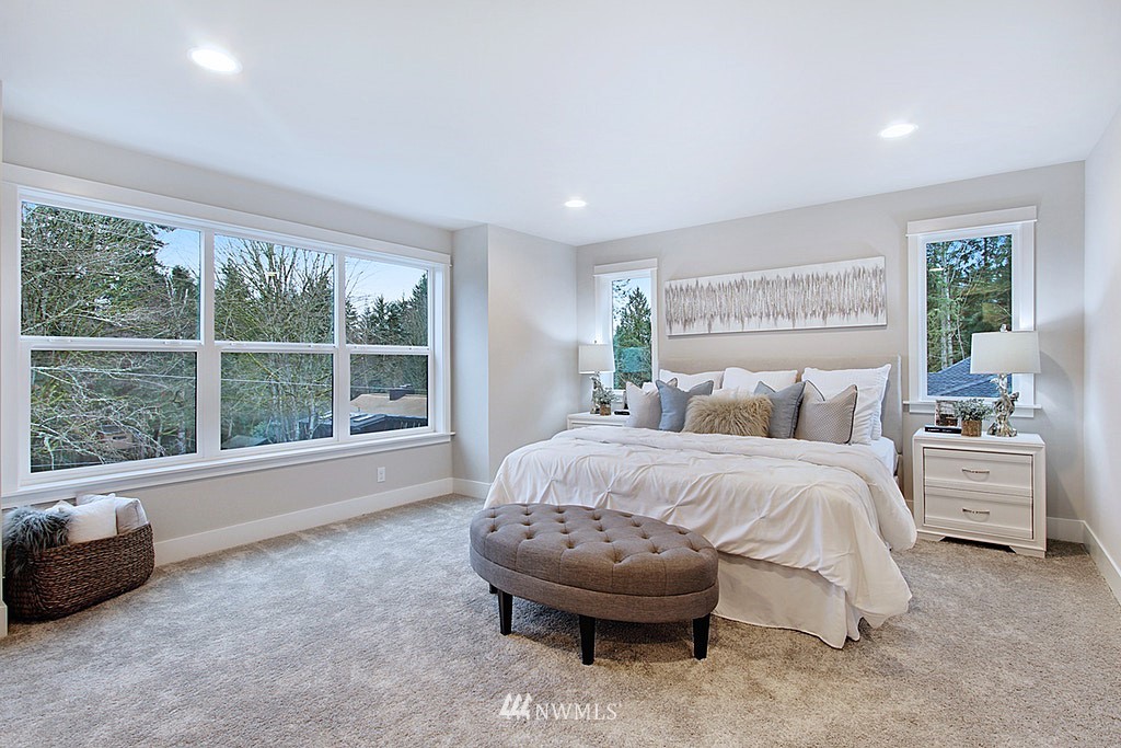 17718 Clover Road Bothell, WA 98012 - Photo 13 of 24 a spacious bedroom with a bed and a large window