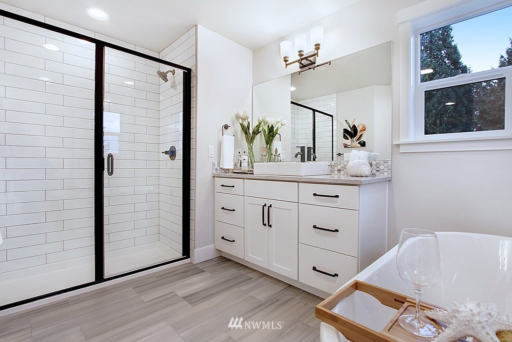 17718 Clover Road Bothell, WA 98012 - Photo 16 of 24 a bathroom with a tub sink and mirror
