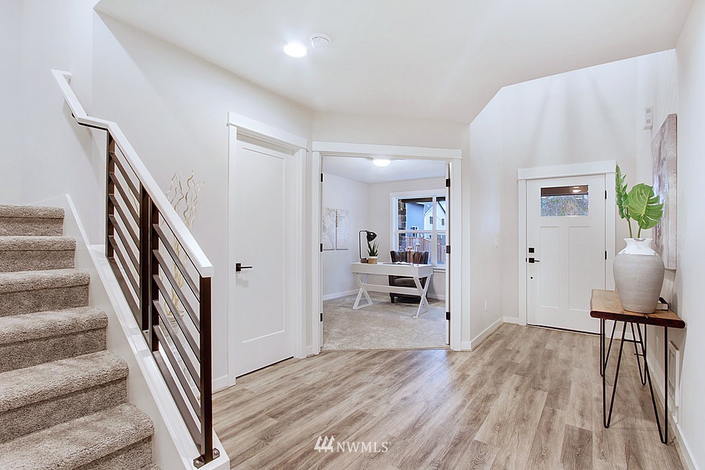 17718 Clover Road Bothell, WA 98012 - Photo 21 of 24 a view of a livingroom with wooden floor and stairs