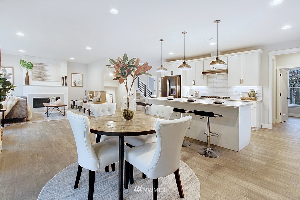 17718 Clover Road Bothell, WA 98012 - Photo 5 of 24 a dining room with stainless steel appliances kitchen island a table and chairs