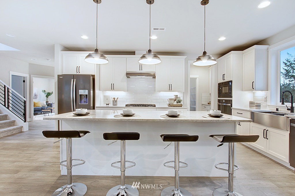 17718 Clover Road Bothell, WA 98012 - Photo 7 of 24 a view of a kitchen with a dining table and chairs