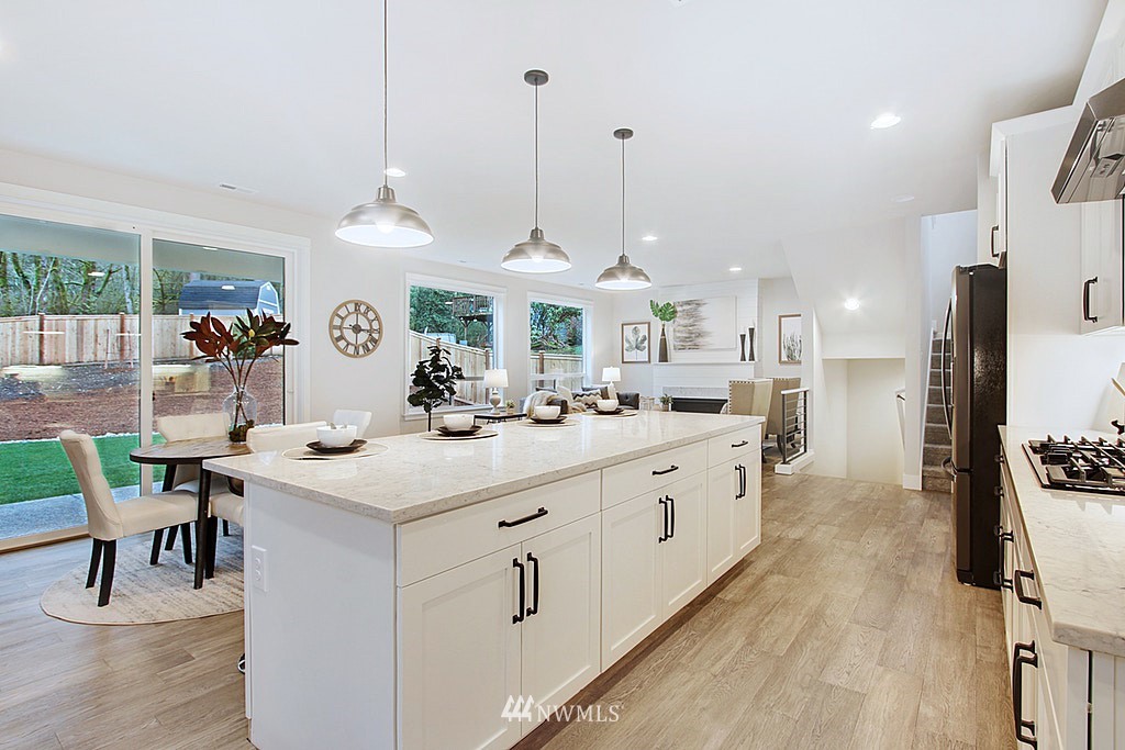 17718 Clover Road Bothell, WA 98012 - Photo 8 of 24 a large white kitchen with lots of counter space and chandelier