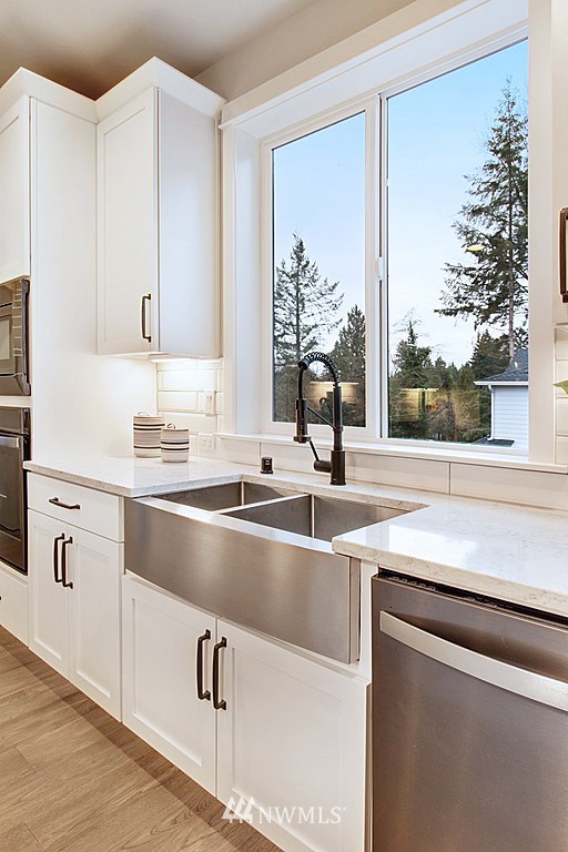 17718 Clover Road Bothell, WA 98012 - Photo 9 of 24 a kitchen with a sink and large window
