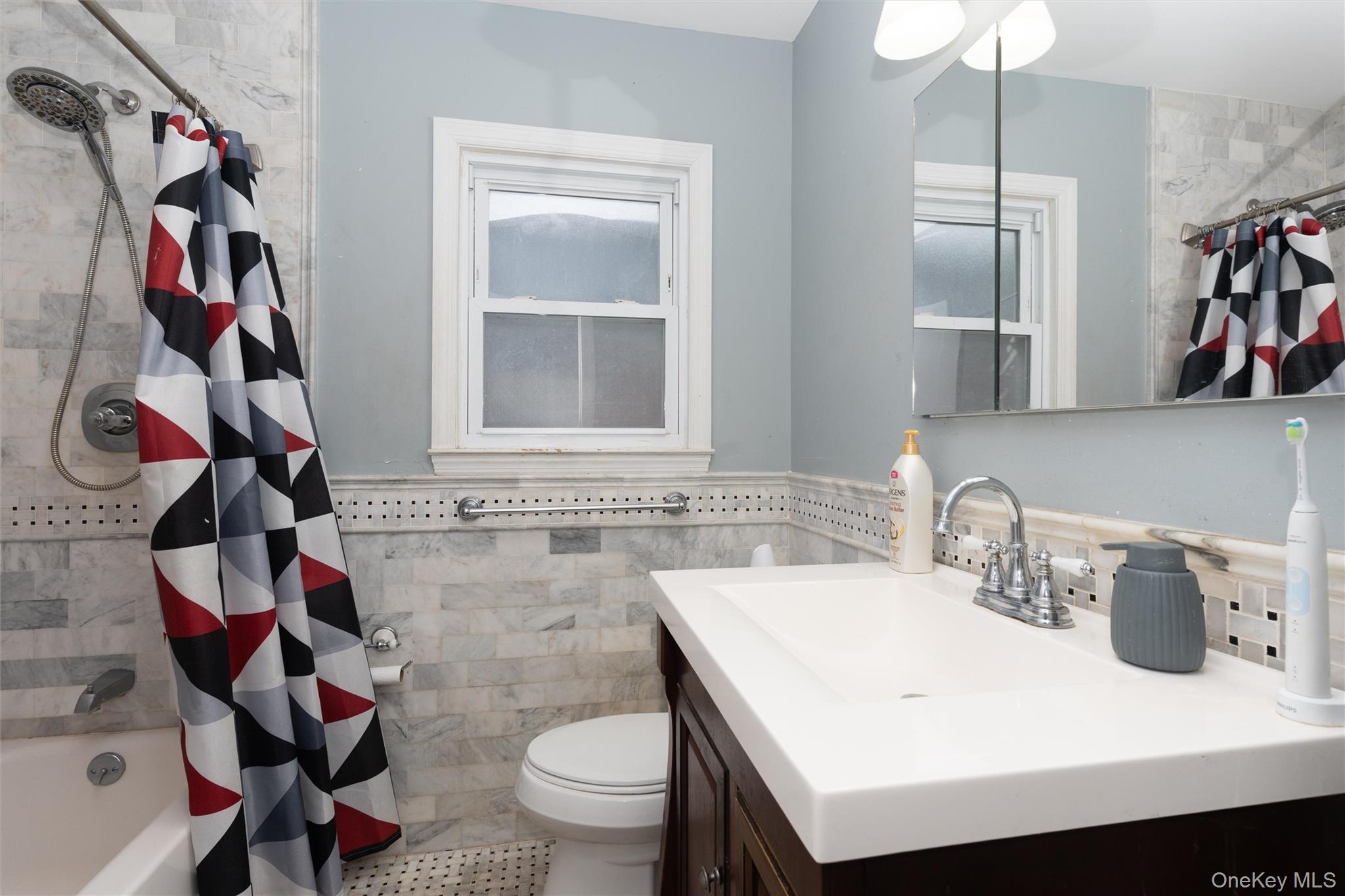 6 Jasper Street Valley Stream, NY 11580 - Photo 15 of 19 a bathroom with a sink a toilet and a shower curtain
