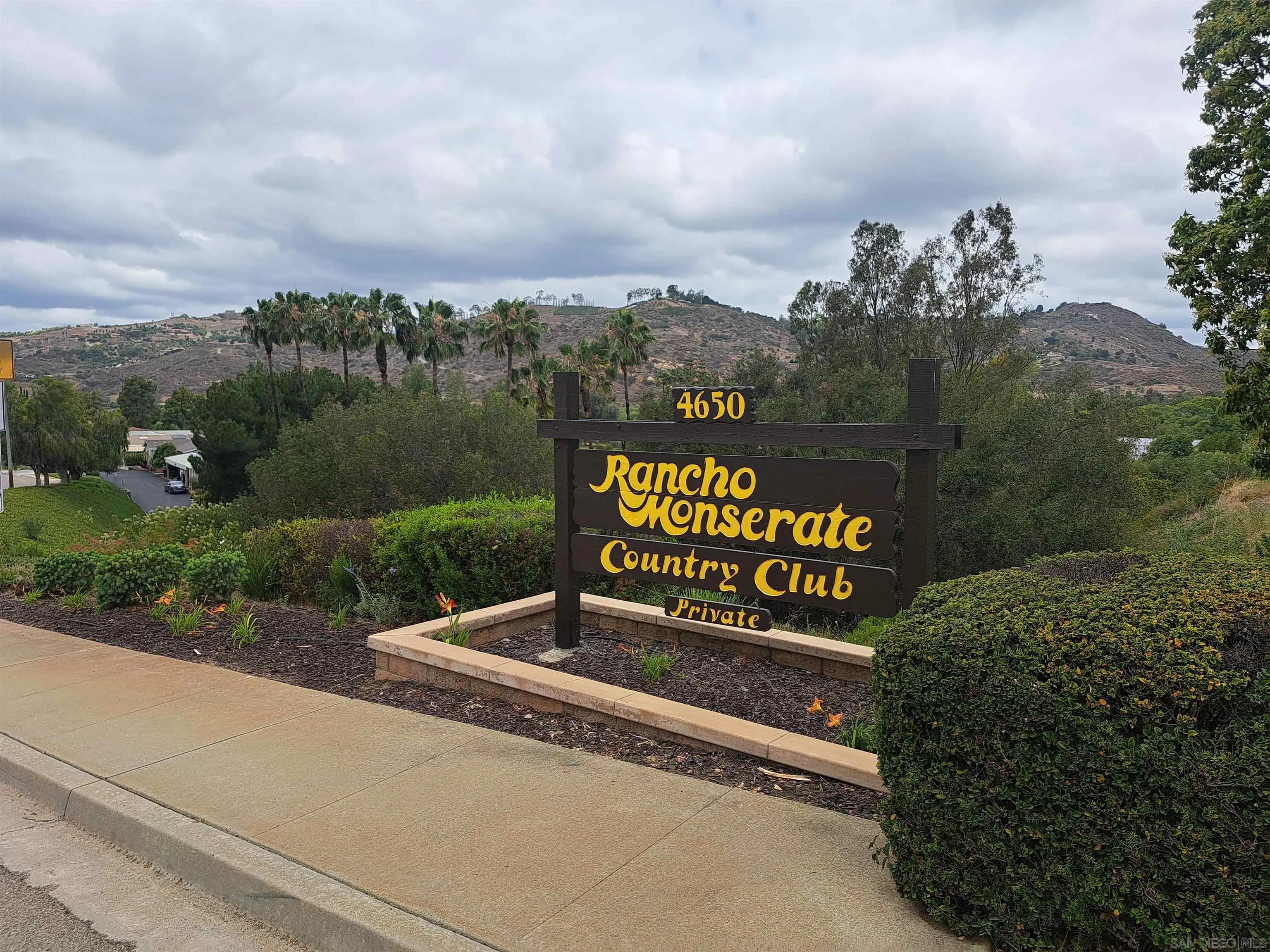 4650 Dulin Road, Unit 12 Fallbrook, CA 92003 - Photo 25 of 36 a view of a street with benches and trees in the background