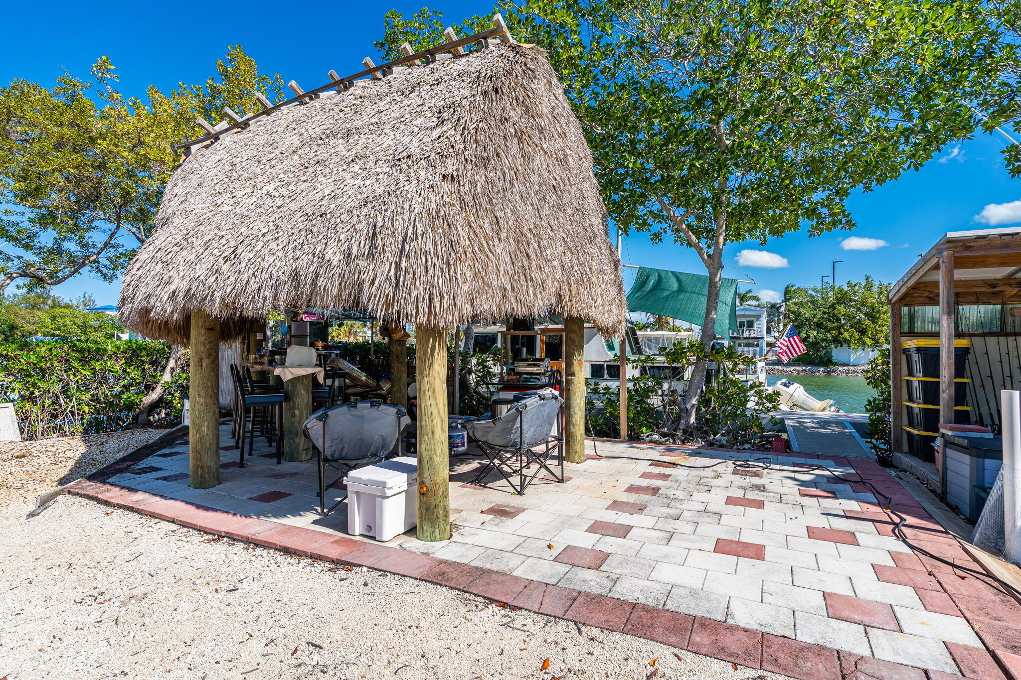 100 Morris Lane Key Largo, FL 33037 - Photo 135 of 192 a view of a patio with table and chairs under an umbrella