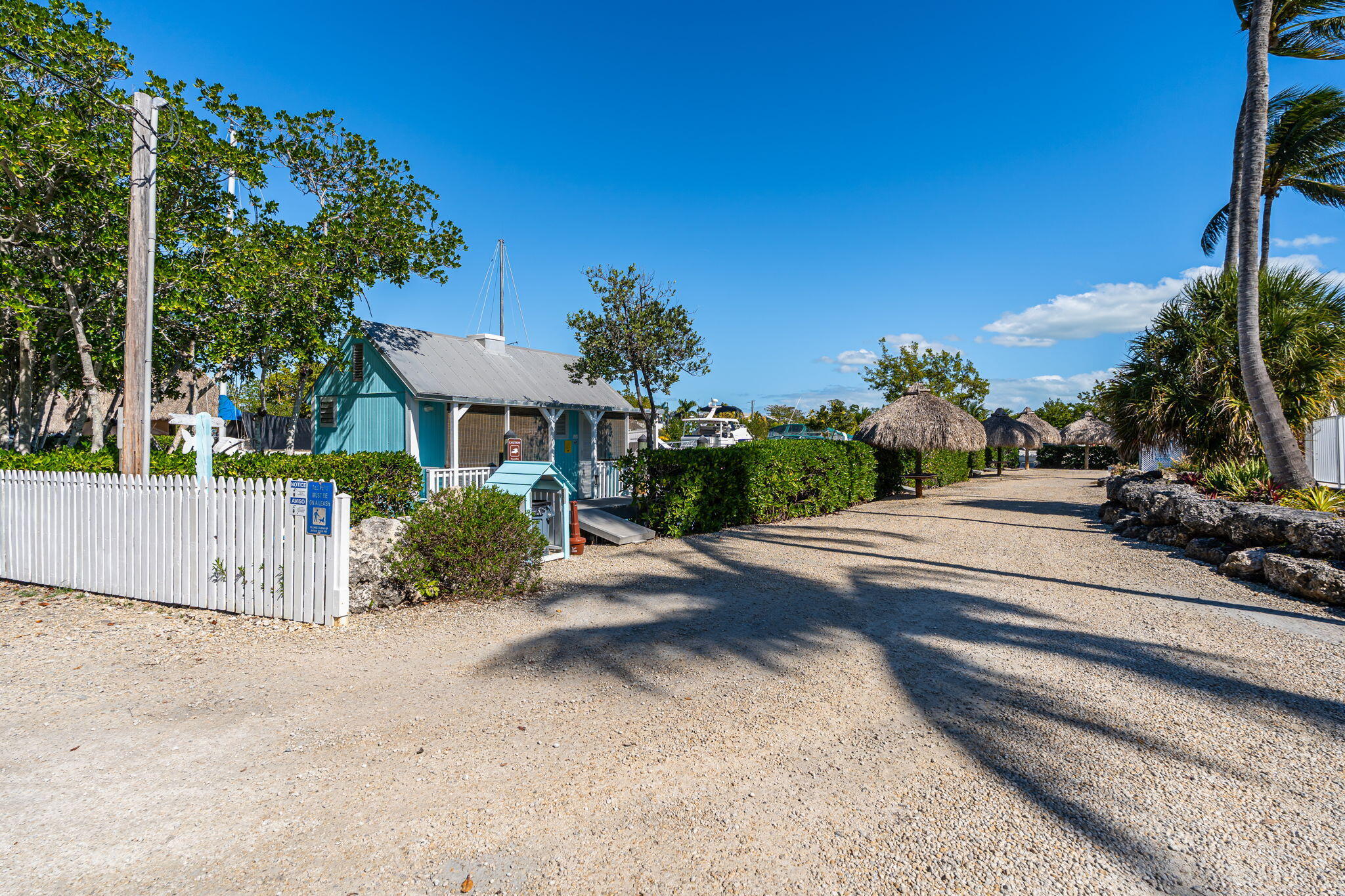 100 Morris Lane, Unit 56 SLIPS Key Largo, FL 33037 - Photo 46 of 56 a view of a house with a yard and table and chairs under an umbrella