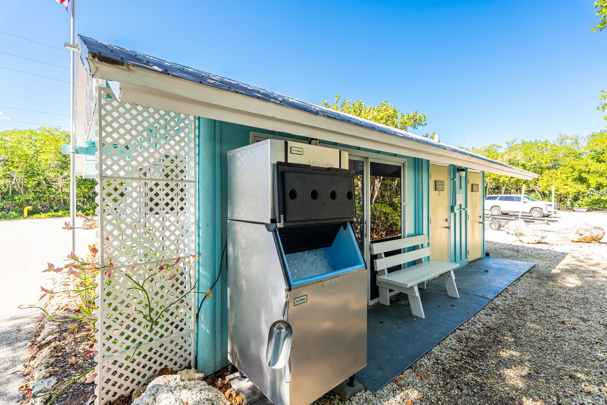 100 Morris Lane Key Largo, FL 33037 - Photo 53 of 192 a view of a patio with table and chairs and potted plants