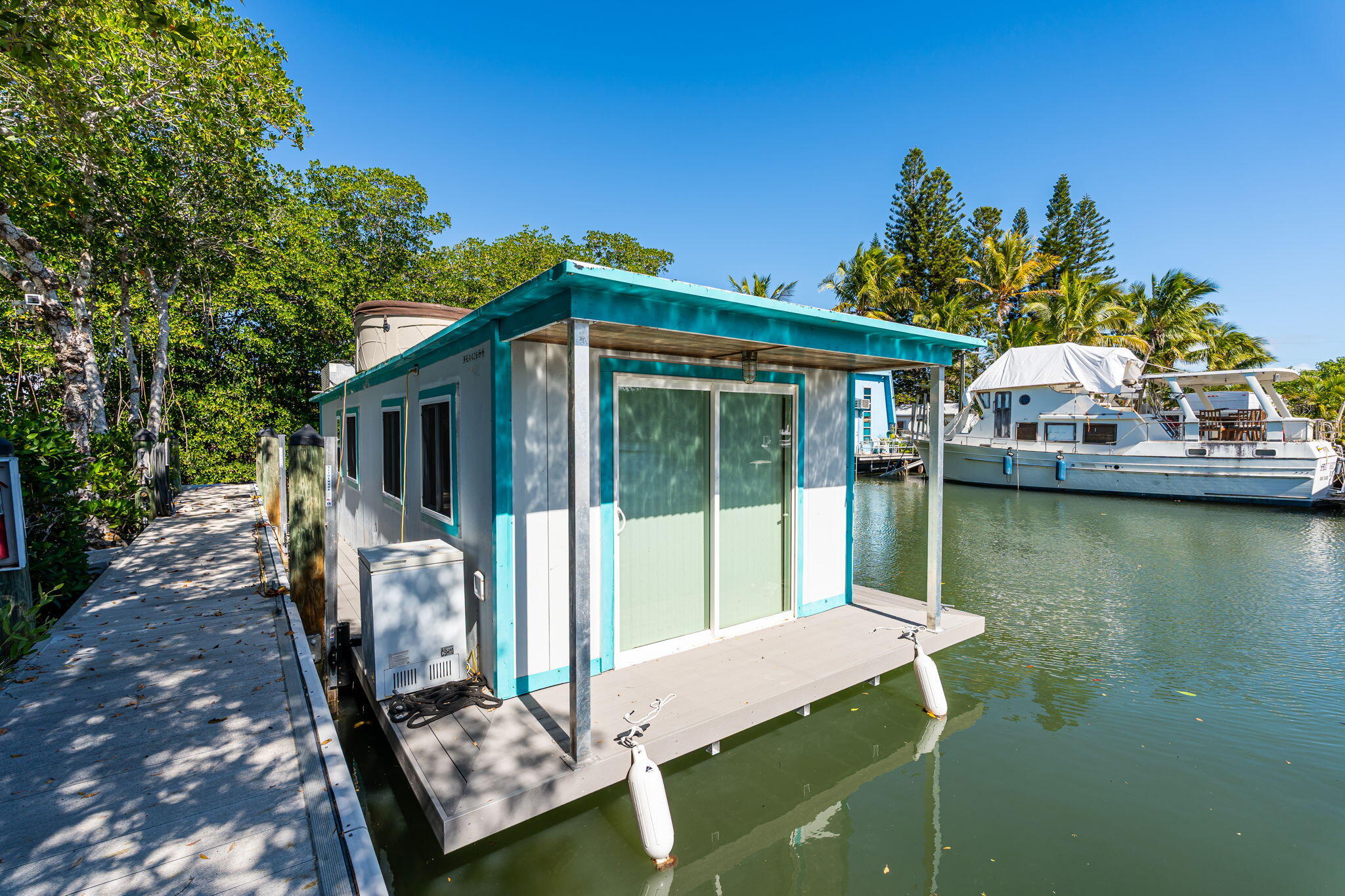 100 Morris Lane Key Largo, FL 33037 - Photo 66 of 192 a front view of a house with a yard table and chairs