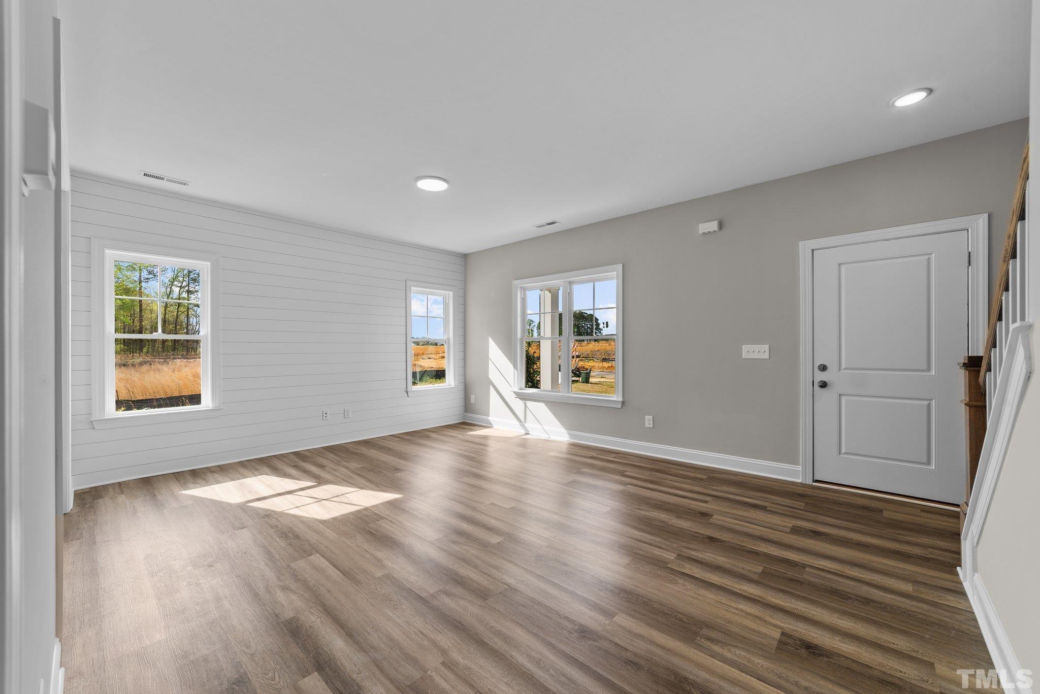 4530 Fairhaven Drive Wilson, NC 27893 - Photo 15 of 49 a view of an empty room with wooden floor and a window