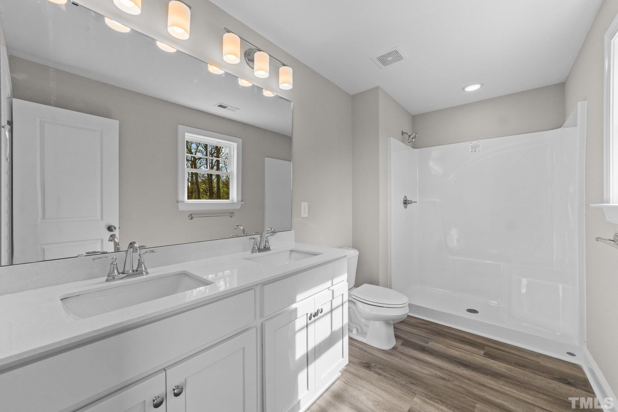 4530 Fairhaven Drive Wilson, NC 27893 - Photo 20 of 49 a bathroom with a double vanity sink toilet and a mirror
