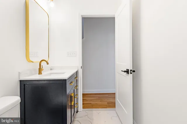 a view of bathroom with a sink and mirror