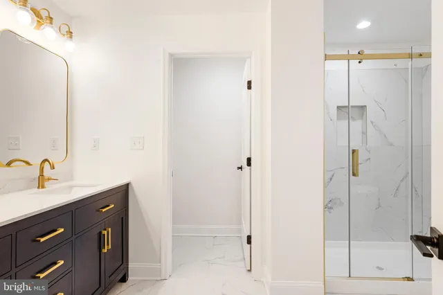 a bathroom with a double vanity sink a mirror and shower