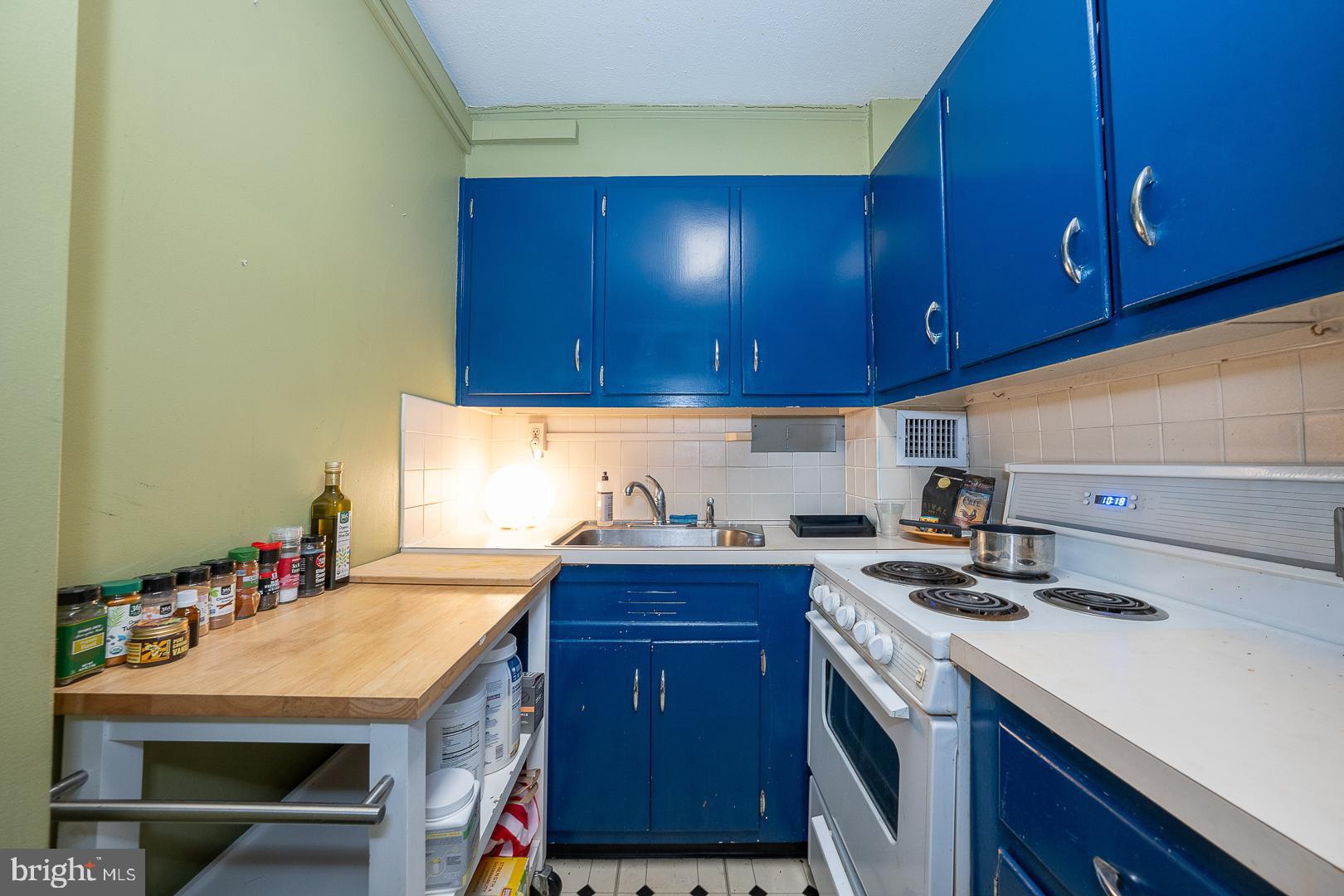 118 South 21st Street, Unit 210 Philadelphia, PA 19103 - Photo 7 of 21 a kitchen with a sink a stove and cabinets