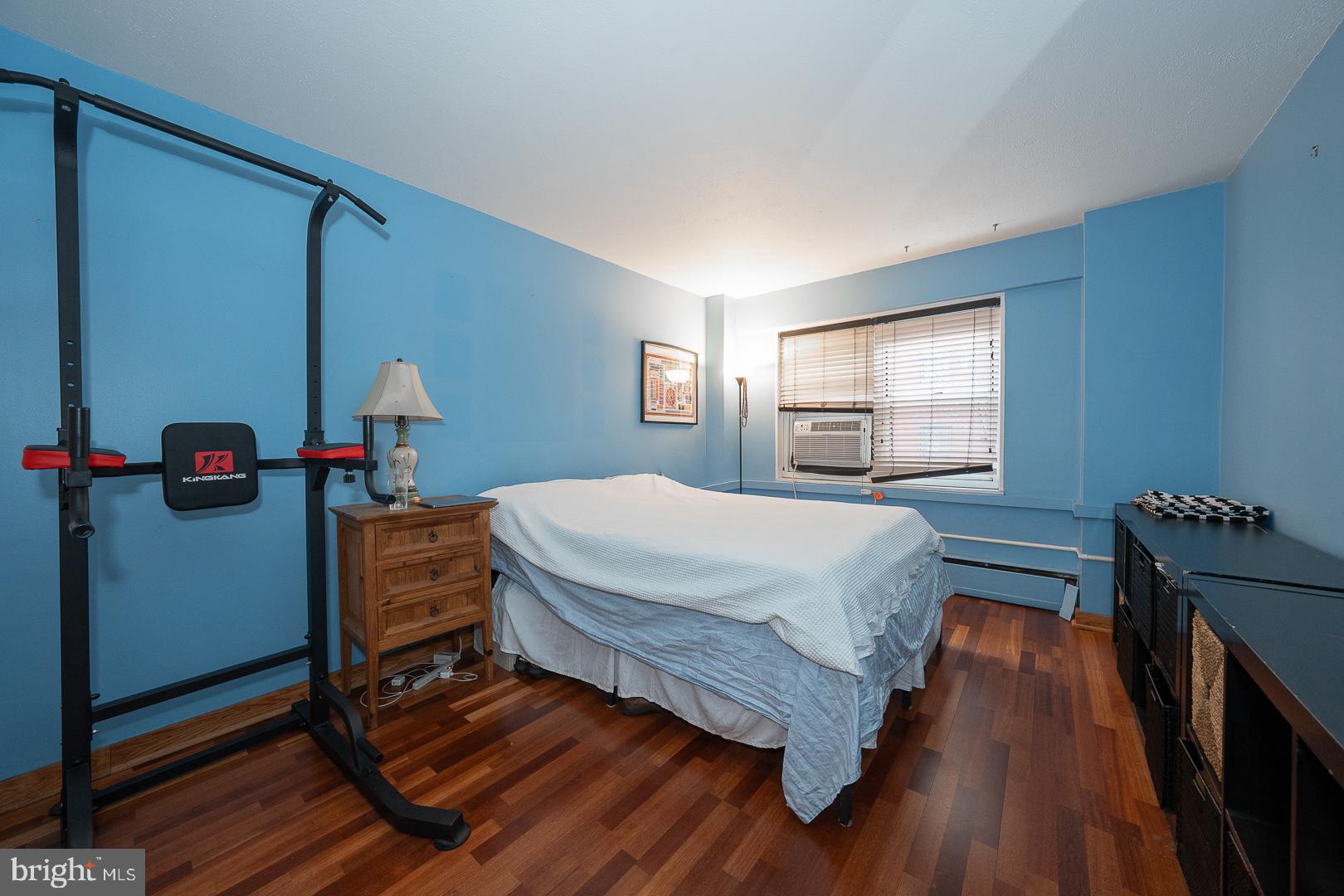 118 South 21st Street, Unit 210 Philadelphia, PA 19103 - Photo 8 of 21 a bedroom with a bed and wooden floor