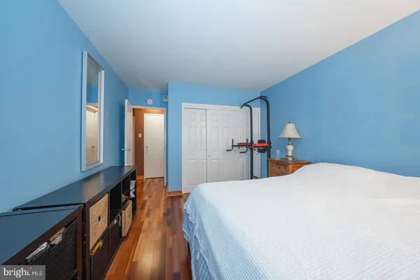 a bedroom with a bed and a large mirror