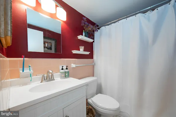 a bathroom with a sink a toilet and a mirror