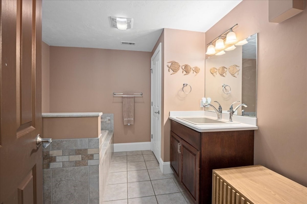 7 Primmett Lane, Unit 7 Worcester, MA 01609 - Photo 33 of 38 a bathroom with a sink a toilet and shower