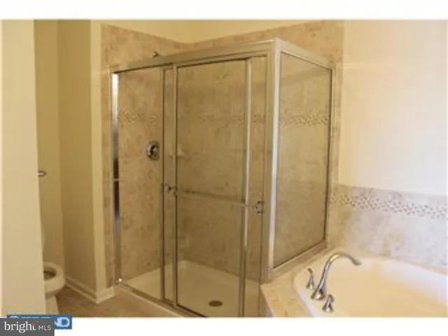 a bathroom with a shower and a bath tub