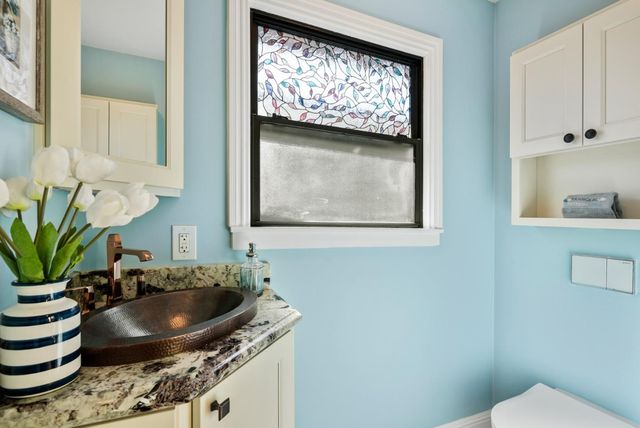 a bathroom with a sink and a mirror with toilet