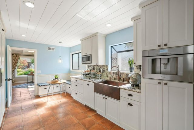a large white kitchen with cabinets