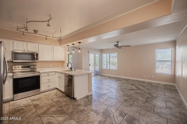 a kitchen with stainless steel appliances a sink stove and refrigerator