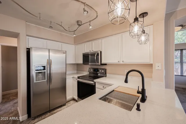 a very nice looking dining room with chandelier