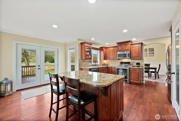 a view of a open kitchen with a sink and dishwasher with a large window