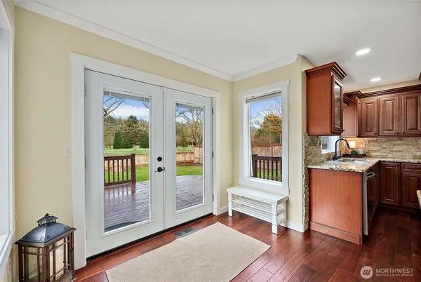 a kitchen with granite countertop stainless steel appliances and wooden cabinets