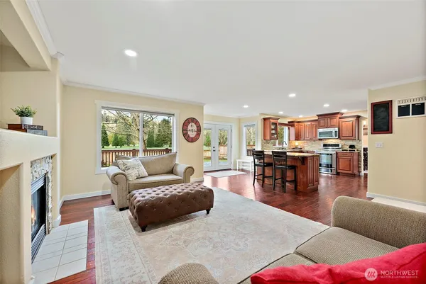 a living room with furniture and kitchen view