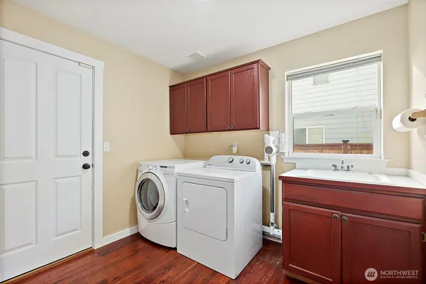 a bathroom with a toilet a sink a mirror and vanity