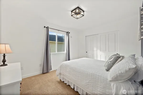a bedroom with furniture and a window