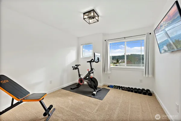 a bedroom with a bed and a chandelier fan