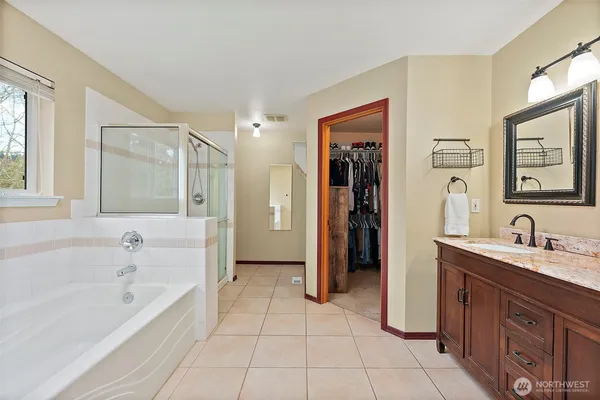 a bathroom with a bathtub and a shower