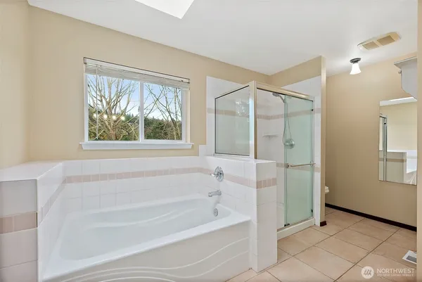 a en suite bathroom with a double vanity sink and a mirror