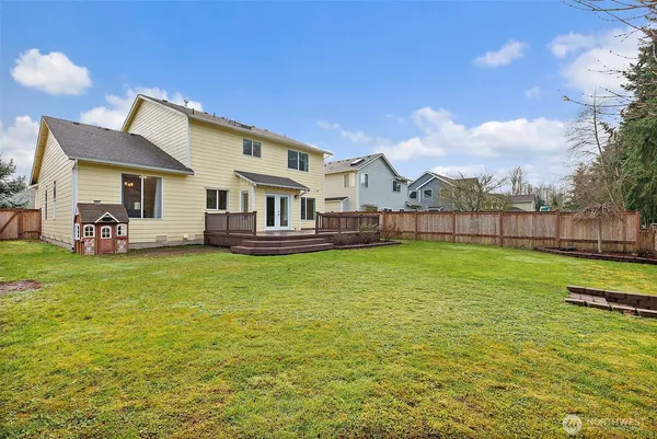 a view of a backyard with wooden fence