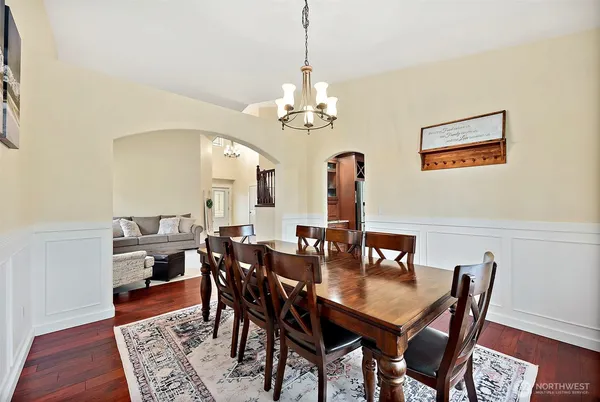a large kitchen with stainless steel appliances granite countertop a lot of counter space and wooden floors
