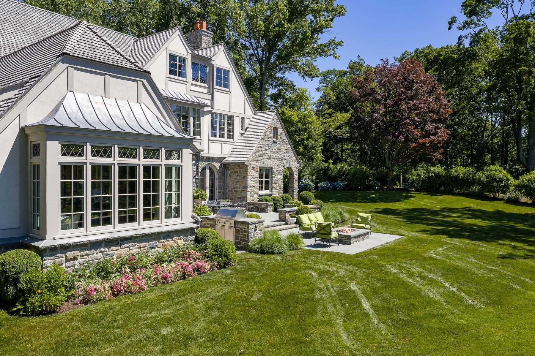 16 Raiders Lane Darien, CT 06820 - Photo 19 of 53 a front view of a house with garden and sitting area