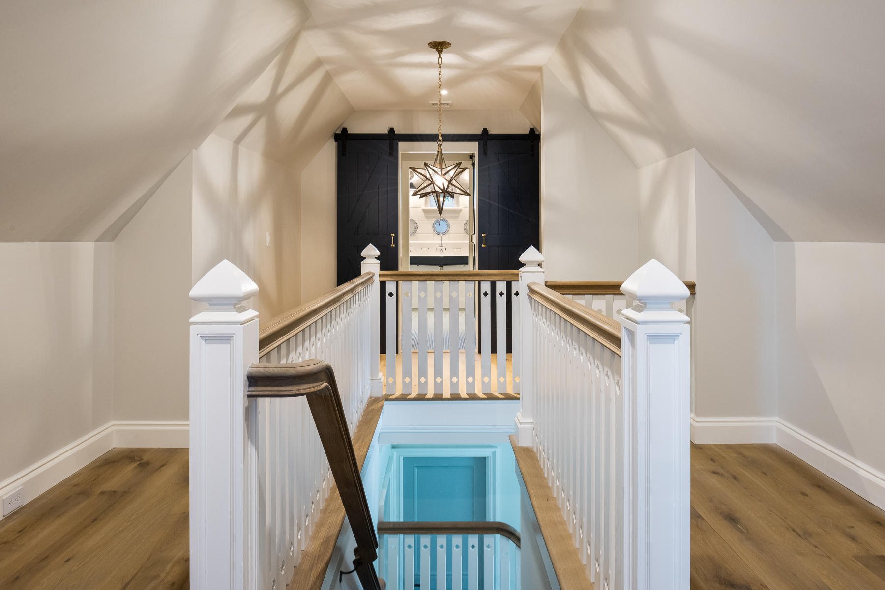 16 Raiders Lane Darien, CT 06820 - Photo 40 of 53 a view of a hallway with wooden floor staircase and a livingroom
