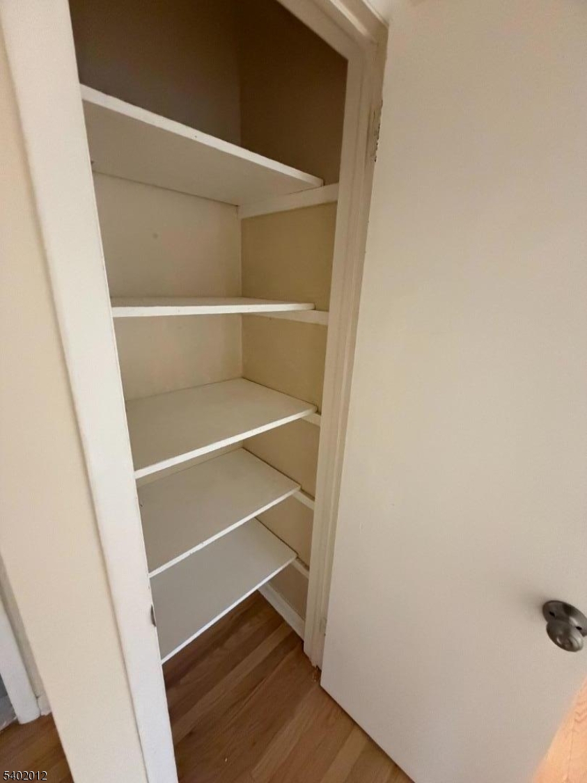 360 Highland Avenue, Unit 2 Passaic, NJ 07055 - Photo 15 of 23 a view of walk in closet with wooden floor