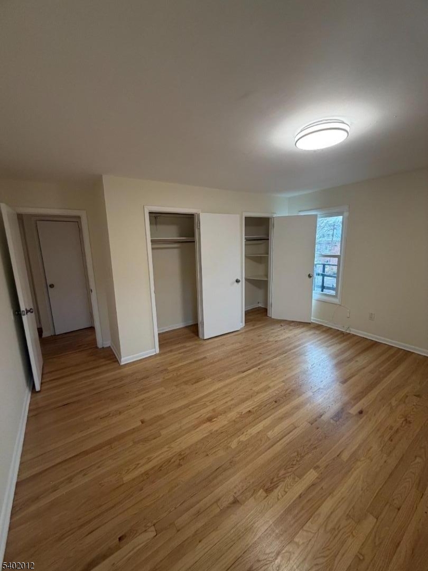 360 Highland Avenue, Unit 2 Passaic, NJ 07055 - Photo 17 of 23 a view of empty room with wooden floor