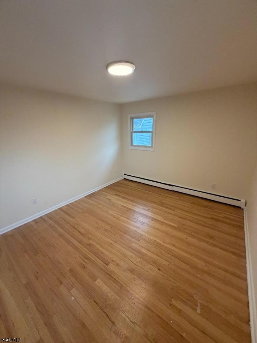 360 Highland Avenue, Unit 2 Passaic, NJ 07055 - Photo 22 of 23 a view of empty room with wooden floor