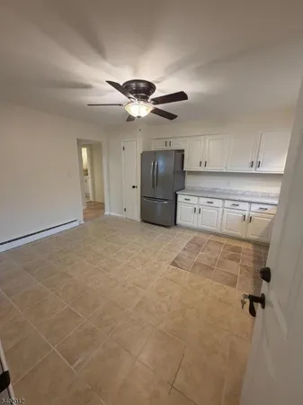 a view of a kitchen with a sink and cabinets