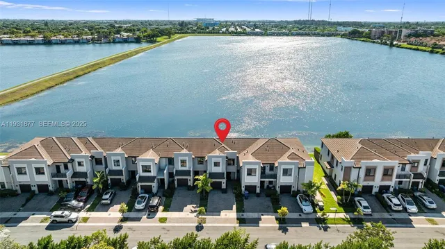 an aerial view of a houses with a swimming pool
