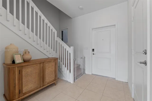 a kitchen with a refrigerator and a stove top oven