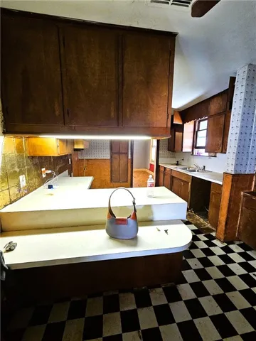 a room with a table chairs and white appliances